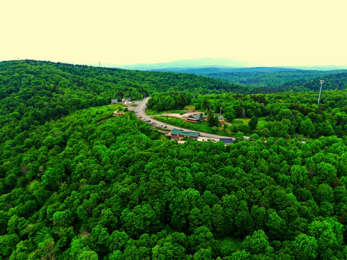 High-altitude aerial view of Hogback Mountain area with winding road and Vermont mountain ridgeline